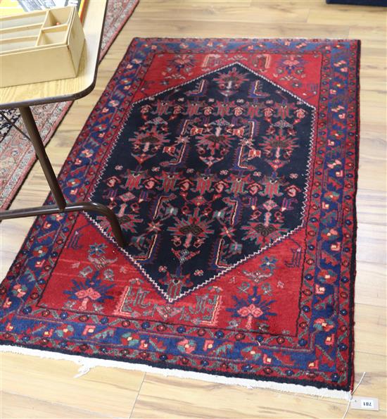 A Persian red and blue ground rug, 175 x 112cm